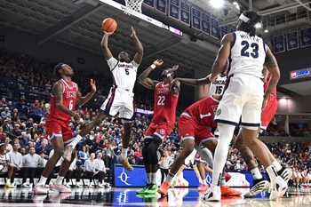 Jan 4, 2026; Spokane, Washington, USA; Gonzaga Bulldogs forward Emmanuel Innocenti (5) shoots the ball against Loyola Marymount Lions center Rick Issanza (22) in the second half at McCarthey Athletic Center. Mandatory Credit: James Snook-Imagn Images