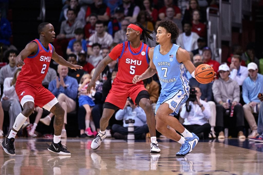 Jan 3, 2026; Dallas, Texas, USA; North Carolina Tar Heels guard Seth Trimble (7) looks to pass the ball by SMU Mustangs guard Jaron Pierre Jr. (5) and guard Boopie Miller (2) during the game between the Mustangs and the Tar Heels at Moody Coliseum. Mandatory Credit: Jerome Miron-Imagn Images