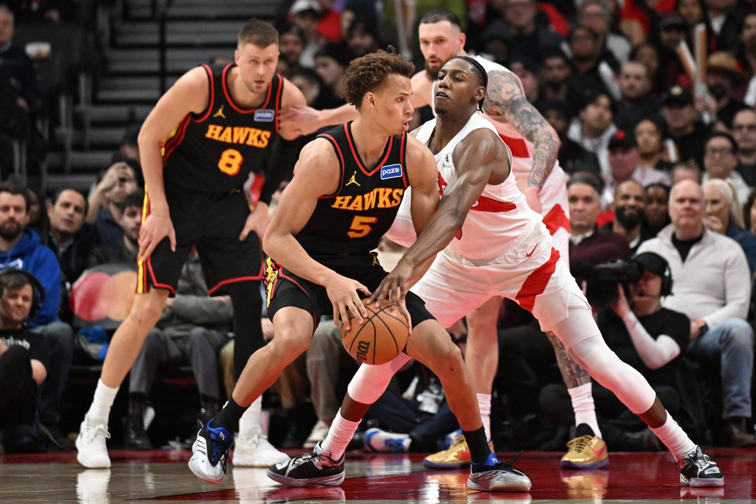 Jan 5, 2026; Toronto, Ontario, CAN;  Toronto Raptors forward RJ Barrett (9) knocks the ball from the grasp of Atlanta Hawks guard Dyson Daniels (5) in the second half at Scotiabank Arena. Mandatory Credit: Dan Hamilton-Imagn Images