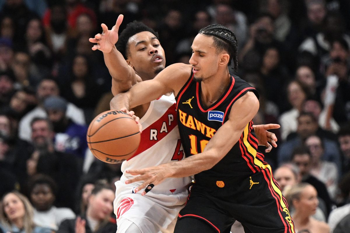 Jan 5, 2026; Toronto, Ontario, CAN;  Atlanta Hawks forward Zaccharie Risacher (10) passes the ball away from Toronto Raptors forward Scottie Barnes (4) in the second half at Scotiabank Arena. Mandatory Credit: Dan Hamilton-Imagn Images