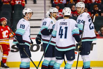 Jan 5, 2026; Calgary, Alberta, CAN; Seattle Kraken center Matty Beniers (10) celebrates his goal with teammates against the Calgary Flames during the third period at Scotiabank Saddledome. Mandatory Credit: Sergei Belski-Imagn Images