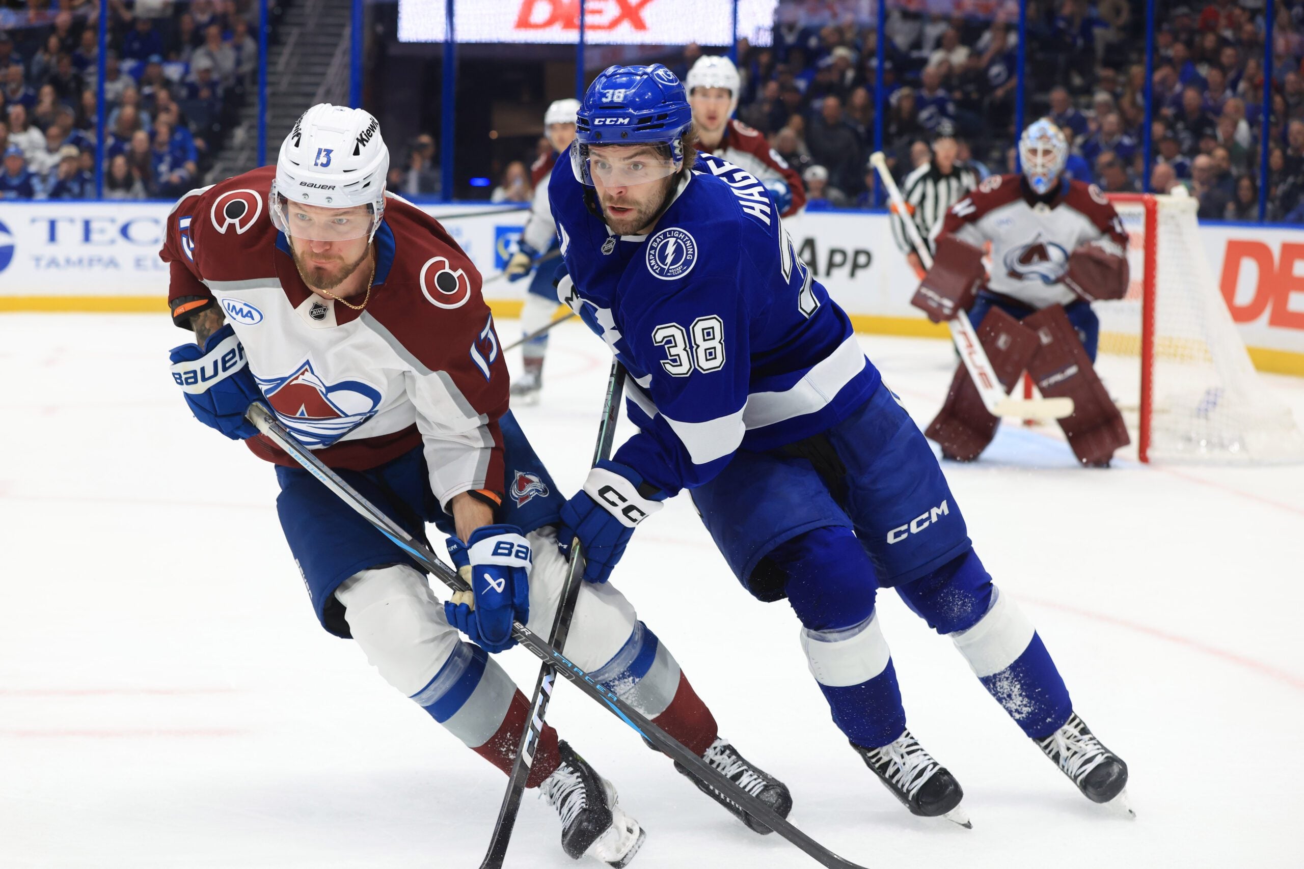 Jan 6, 2026; Tampa, Florida, USA; Colorado Avalanche right wing Valeri Nichushkin (13) and Tampa Bay Lightning left wing Brandon Hagel (38) skate after the puck during the third period at Benchmark International Arena. Mandatory Credit: Kim Klement Neitzel-Imagn Images
