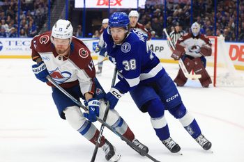 Jan 6, 2026; Tampa, Florida, USA; Colorado Avalanche right wing Valeri Nichushkin (13) and Tampa Bay Lightning left wing Brandon Hagel (38) skate after the puck during the third period at Benchmark International Arena. Mandatory Credit: Kim Klement Neitzel-Imagn Images