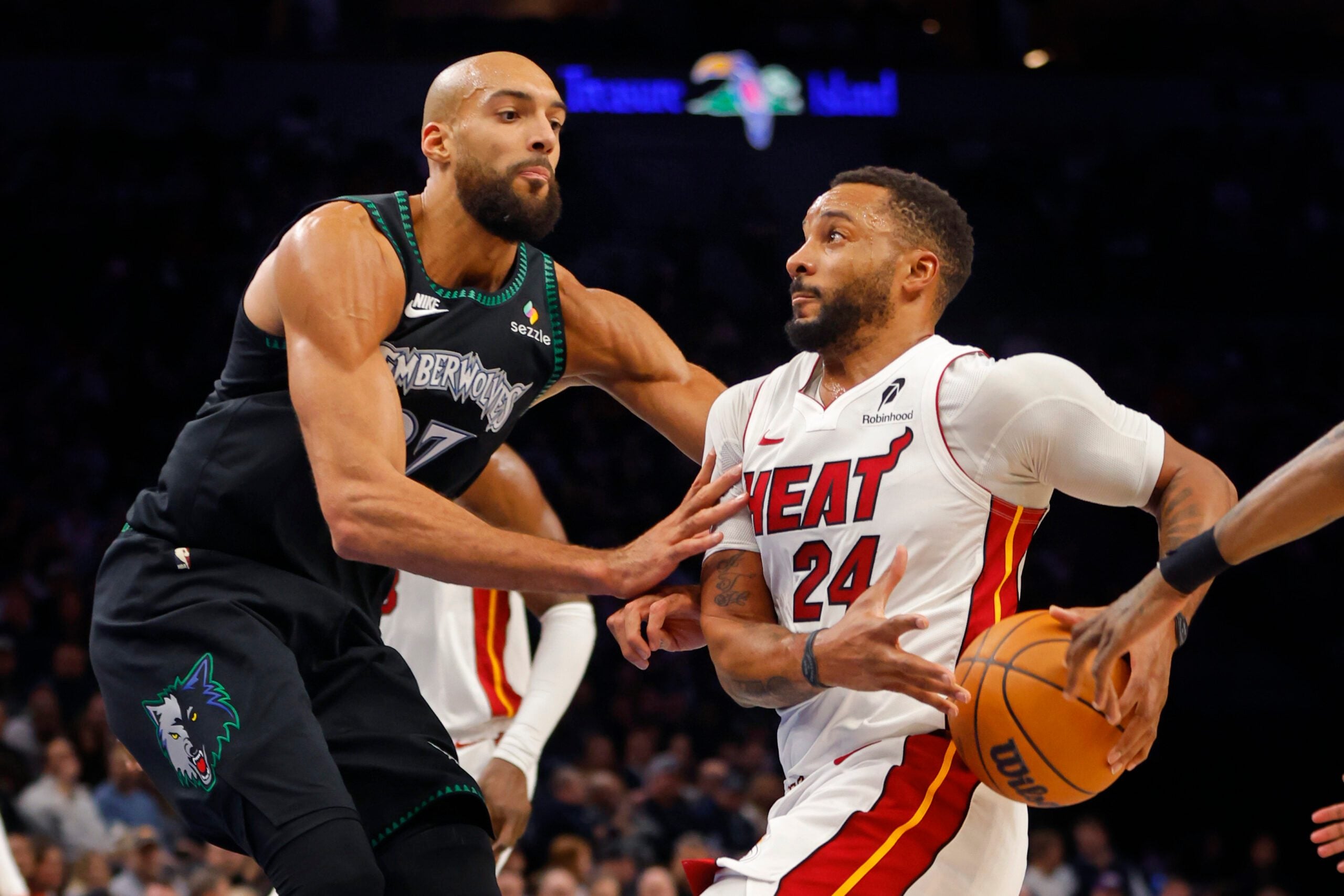 Jan 6, 2026; Minneapolis, Minnesota, USA; Miami Heat guard Norman Powell (24) goes to the basket against Minnesota Timberwolves center Rudy Gobert (27) in the third quarter at Target Center. Mandatory Credit: Bruce Kluckhohn-Imagn Images