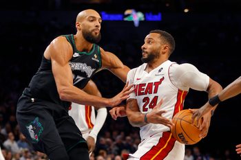 Jan 6, 2026; Minneapolis, Minnesota, USA; Miami Heat guard Norman Powell (24) goes to the basket against Minnesota Timberwolves center Rudy Gobert (27) in the third quarter at Target Center. Mandatory Credit: Bruce Kluckhohn-Imagn Images