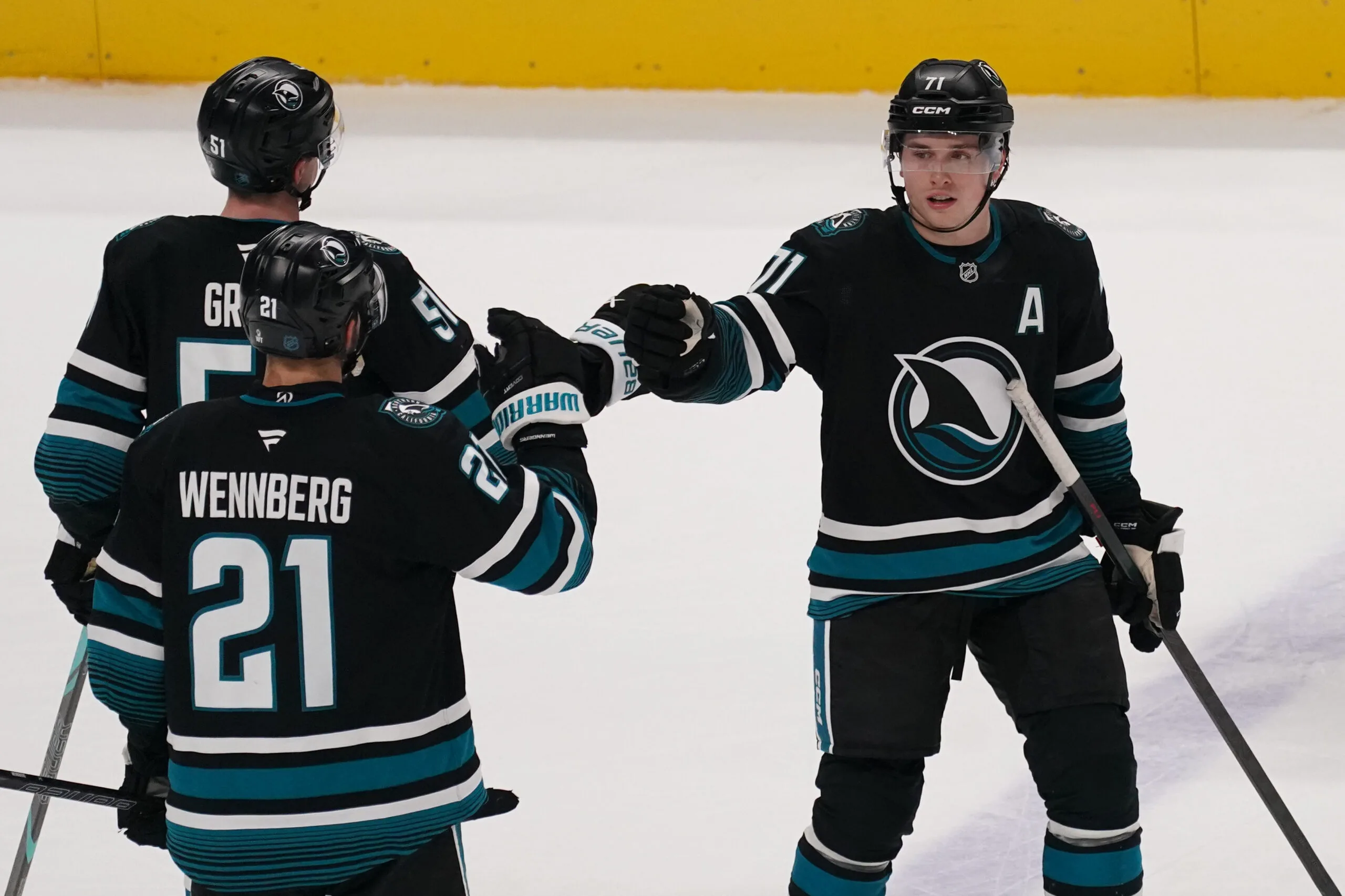 Jan 6, 2026; San Jose, California, USA;  San Jose Sharks center Macklin Celebrini (71) is congratulated by center Alexander Wennberg (21) and right wing Collin Graf (51) after scoring a goal against the Columbus Blue Jackets in the third period at SAP Center at San Jose. Mandatory Credit: David Gonzales-Imagn Images