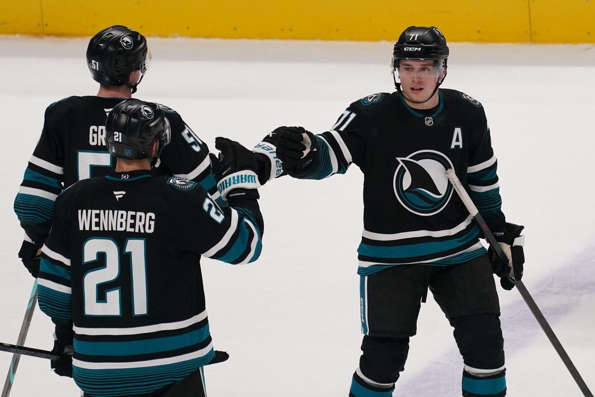 Jan 6, 2026; San Jose, California, USA;  San Jose Sharks center Macklin Celebrini (71) is congratulated by center Alexander Wennberg (21) and right wing Collin Graf (51) after scoring a goal against the Columbus Blue Jackets in the third period at SAP Center at San Jose. Mandatory Credit: David Gonzales-Imagn Images