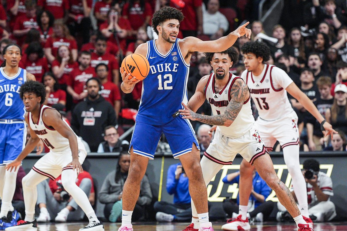 Duke Blue Devils forward Cameron Boozer (12) directs a play as Louisville Cardinals guard J'vonne Hadley (1) guards during a conference ACC game. January 6, 2026.