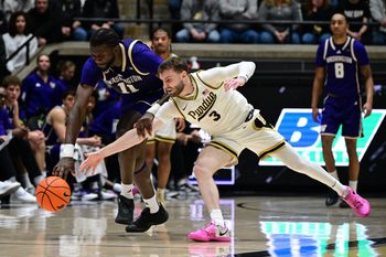 Jan 7, 2026; West Lafayette, Indiana, USA; Purdue Boilermakers guard Braden Smith (3) and Washington Huskies center Franck Kepnang (11) dive after a loose ball during the first half at Mackey Arena. Mandatory Credit: Marc Lebryk-Imagn Images