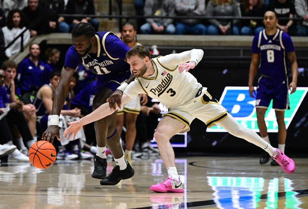 Jan 7, 2026; West Lafayette, Indiana, USA; Purdue Boilermakers guard Braden Smith (3) and Washington Huskies center Franck Kepnang (11) dive after a loose ball during the first half at Mackey Arena. Mandatory Credit: Marc Lebryk-Imagn Images