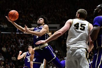 Jan 7, 2026; West Lafayette, Indiana, USA; Washington Huskies guard Desmond Claude (1) shoots the ball in front of Purdue Boilermakers center Oscar Cluff (45) during the first half at Mackey Arena. Mandatory Credit: Marc Lebryk-Imagn Images