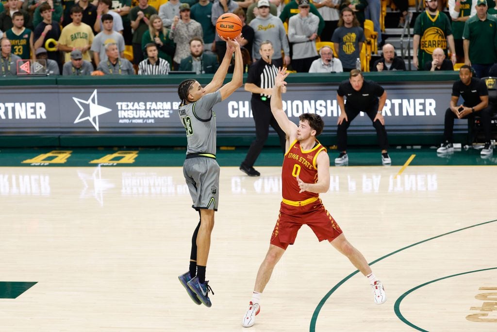 Jan 7, 2026; Waco, Texas, USA; Baylor Bears guard Cameron Carr (43) scores a three-point basket against Iowa State Cyclones guard Nate Heise (0) during the first half at Paul and Alejandra Foster Pavilion. Mandatory Credit: Chris Jones-Imagn Images