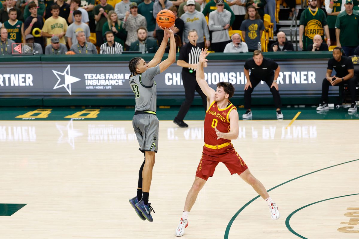 Jan 7, 2026; Waco, Texas, USA; Baylor Bears guard Cameron Carr (43) scores a three-point basket against Iowa State Cyclones guard Nate Heise (0) during the first half at Paul and Alejandra Foster Pavilion. Mandatory Credit: Chris Jones-Imagn Images