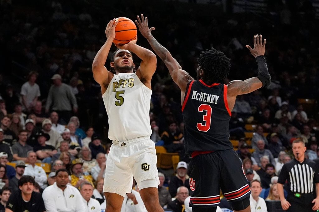 Jan 7, 2026; Boulder, Colorado, USA; Colorado Buffaloes guard Josiah Sanders (5) shoots the ball over Utah Utes guard Don McHenry (3) in the second half at CU Events Center. Mandatory Credit: Ron Chenoy-Imagn Images