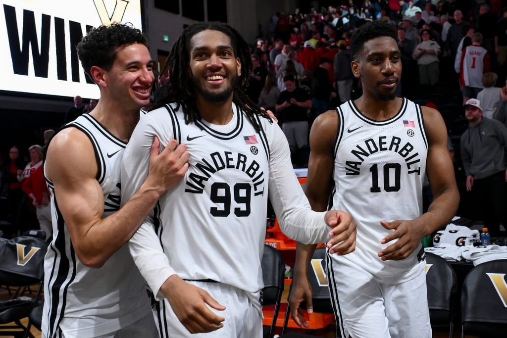 Jan 7, 2026; Nashville, Tennessee, USA; Vanderbilt Commodores guard Miles Keeffe (25), forward Devin McGlockton (99), and forward Ak Okereke (10) celebrate the win against the Alabama Crimson Tide during the second half at Memorial Gymnasium. Mandatory Credit: Steve Roberts-Imagn Images