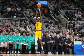 Jan 7, 2026; San Antonio, Texas, USA;  Los Angeles Lakers forward Jarred Vanderbilt (2) shoots in front of the San Antonio Spurs’ bench in the second half at Frost Bank Center. Mandatory Credit: Daniel Dunn-Imagn Images