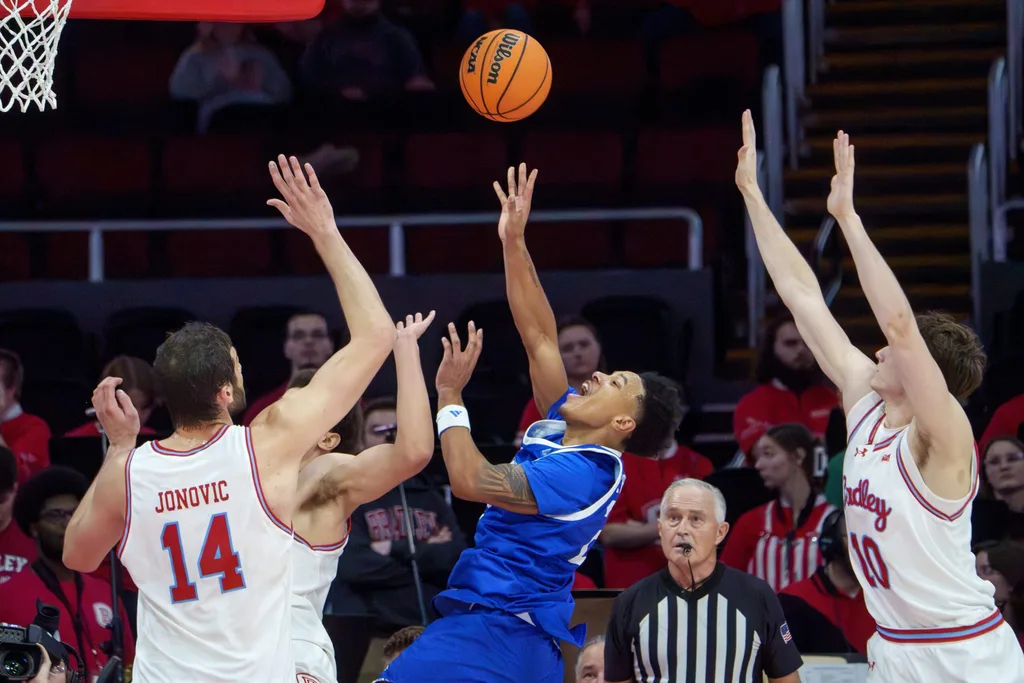 Drake’s Jaehshon Thomas, middle, gets off a shot between Bradley defenders in the second half of their college basketball game Wednesday, Jan. 7, 2026 at Carver Arena in Peoria. The Braves defeated the Bulldogs 93-66.