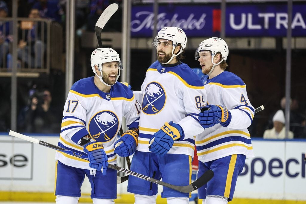 Jan 8, 2026; New York, New York, USA; Buffalo Sabres right wing Alex Tuch (89) celebrates with left wing Jason Zucker (17) and defenseman Bowen Byram (4) after scoring a goal in the second period against the New York Rangers at Madison Square Garden. Mandatory Credit: Wendell Cruz-Imagn Images