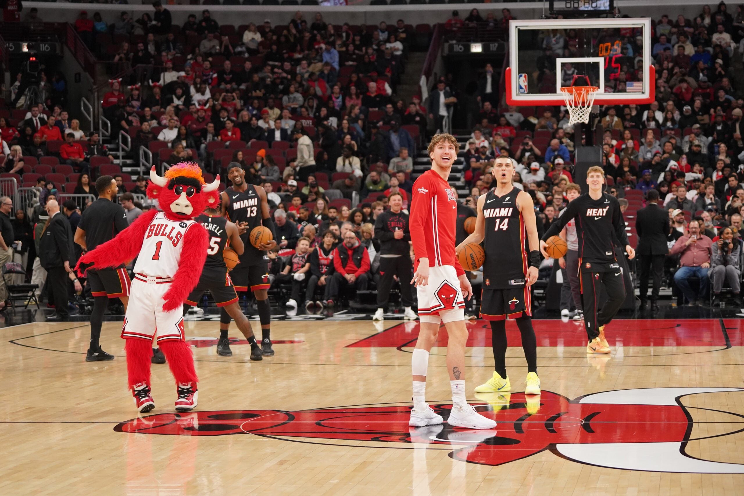 Jan 8, 2026; Chicago, Illinois, USA; Chicago Bulls forward Matas Buzelis (14) and Miami Heat guard Tyler Herro (14) take backward half courts shots as the game against the Miami Heat is delayed because of condensation on the court due to humidity and rain at United Center. Mandatory Credit: David Banks-Imagn Images