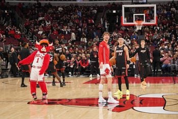 Jan 8, 2026; Chicago, Illinois, USA; Chicago Bulls forward Matas Buzelis (14) and Miami Heat guard Tyler Herro (14) take backward half courts shots as the game against the Miami Heat is delayed because of condensation on the court due to humidity and rain at United Center. Mandatory Credit: David Banks-Imagn Images