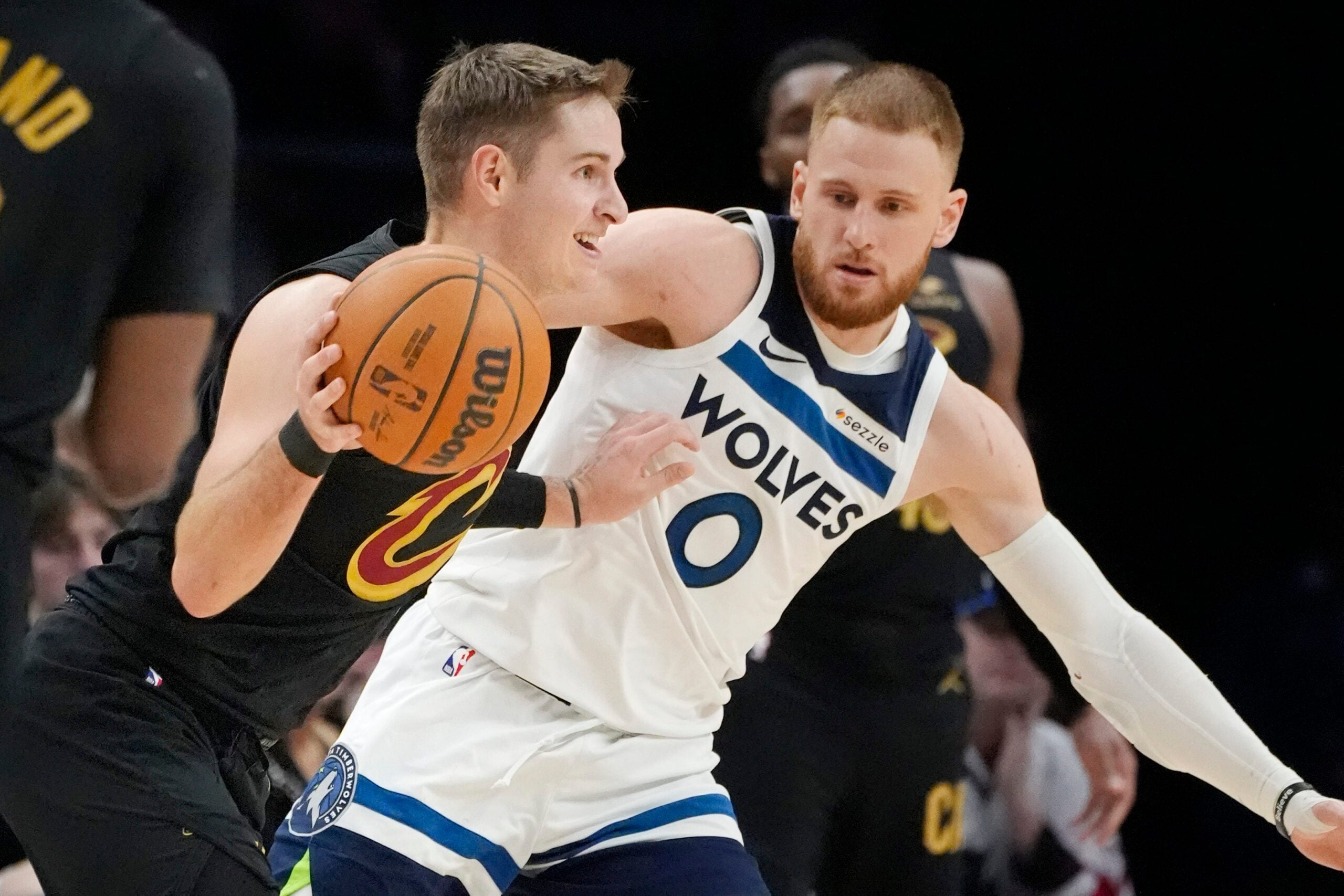 Jan 8, 2026; Minneapolis, Minnesota, USA; Cleveland Cavaliers guard Sam Merrill (5) works around Minnesota Timberwolves guard Donte DiVincenzo (0) in the fourth quarter at Target Center. Mandatory Credit: Bruce Kluckhohn-Imagn Images