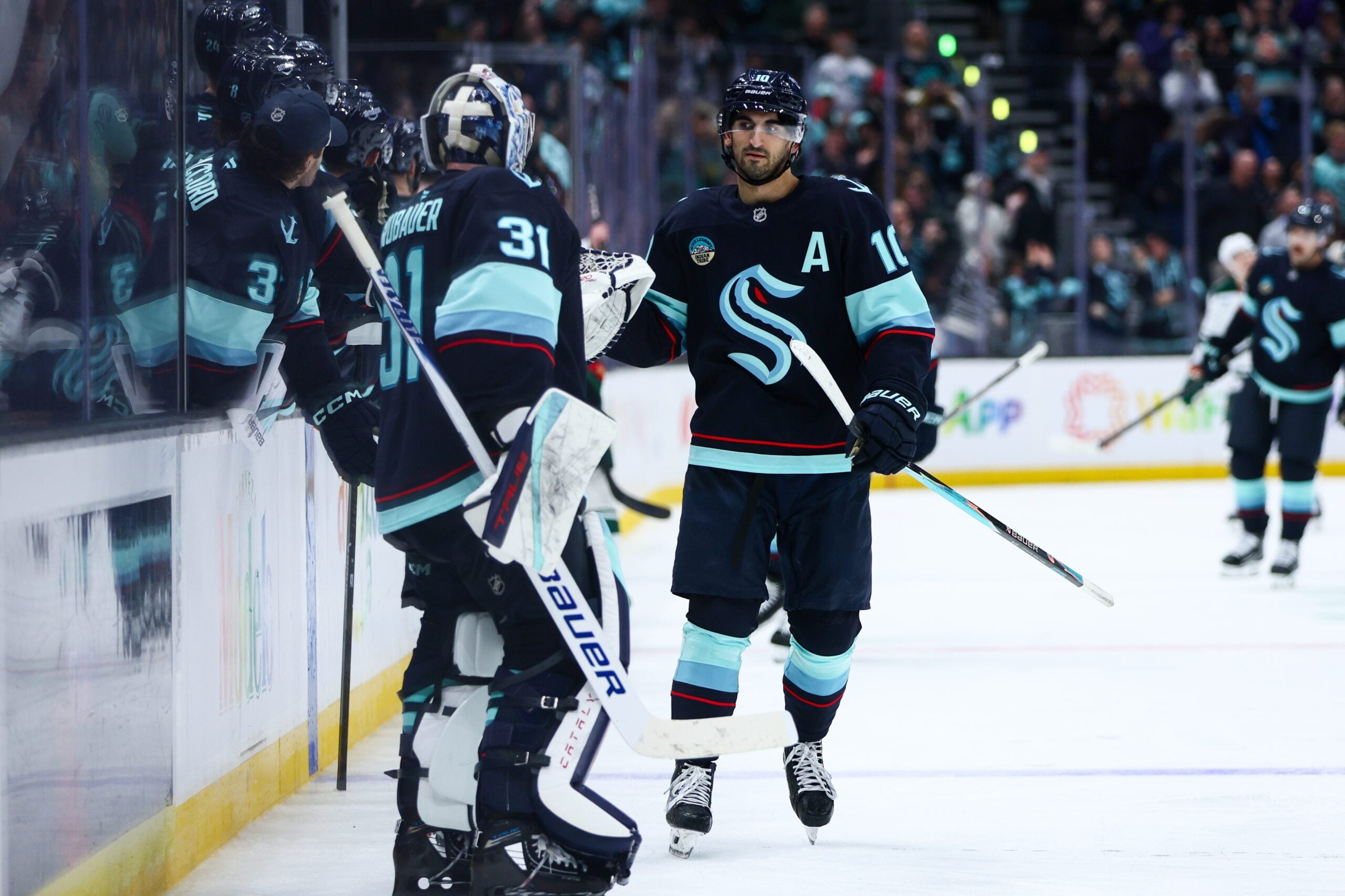 Jan 8, 2026; Seattle, Washington, USA; Seattle Kraken center Matty Beniers (10) celebrates a goal in the third period against the Minnesota Wild at Climate Pledge Arena. Mandatory Credit: Kevin Ng-Imagn Images