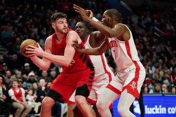 Jan 9, 2026; Portland, Oregon, USA; Portland Trail Blazers center Donovan Clingan (23) looks to pass the ball during the second half against Houston Rockets center Clint Capela (30) and forward Kevin Durant (7) at Moda Center. Mandatory Credit: Troy Wayrynen-Imagn Images