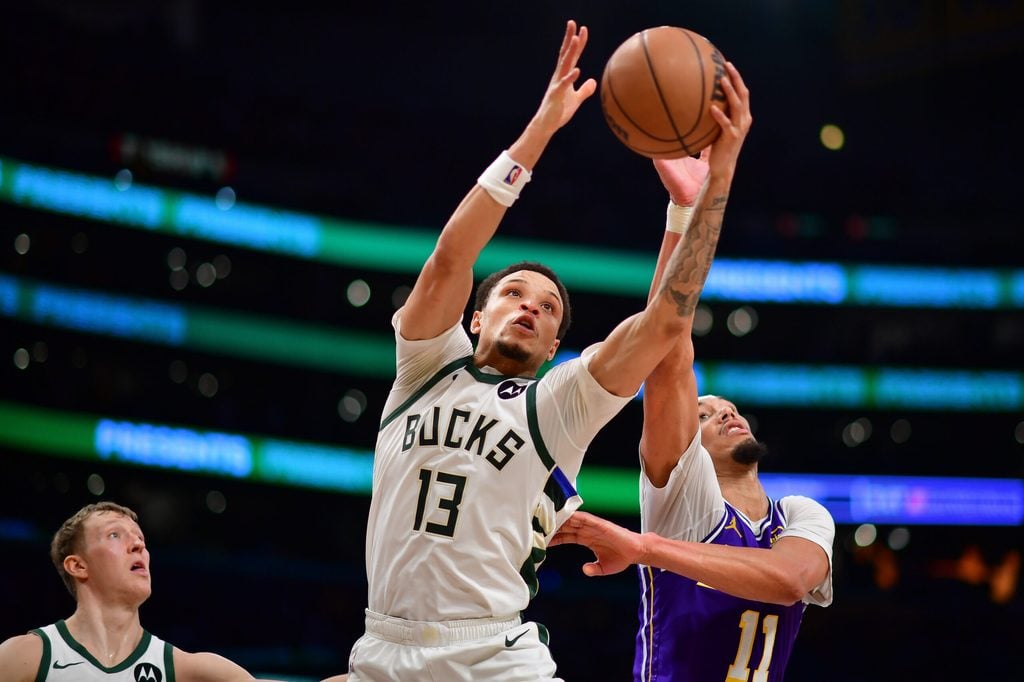Jan 9, 2026; Los Angeles, California, USA; Milwaukee Bucks guard Ryan Rollins (13) gets the rebound against Los Angeles Lakers center Jaxson Hayes (11) during the second half at Crypto.com Arena. Mandatory Credit: Gary A. Vasquez-Imagn Images