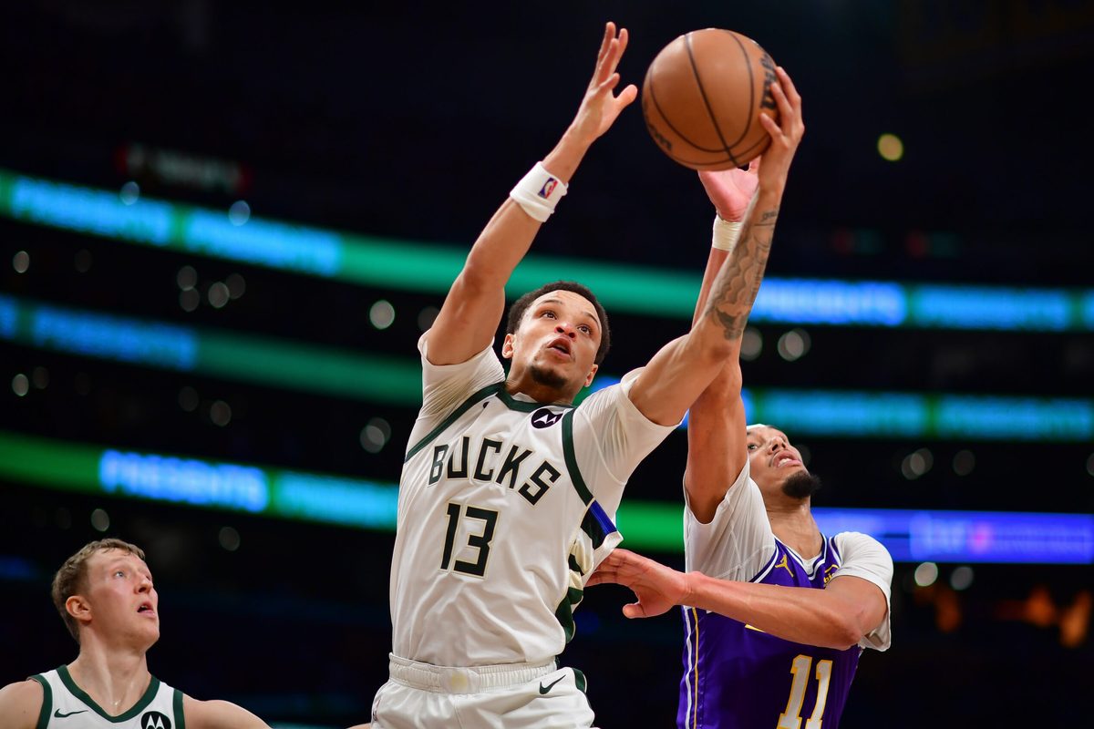 Jan 9, 2026; Los Angeles, California, USA; Milwaukee Bucks guard Ryan Rollins (13) gets the rebound against Los Angeles Lakers center Jaxson Hayes (11) during the second half at Crypto.com Arena. Mandatory Credit: Gary A. Vasquez-Imagn Images