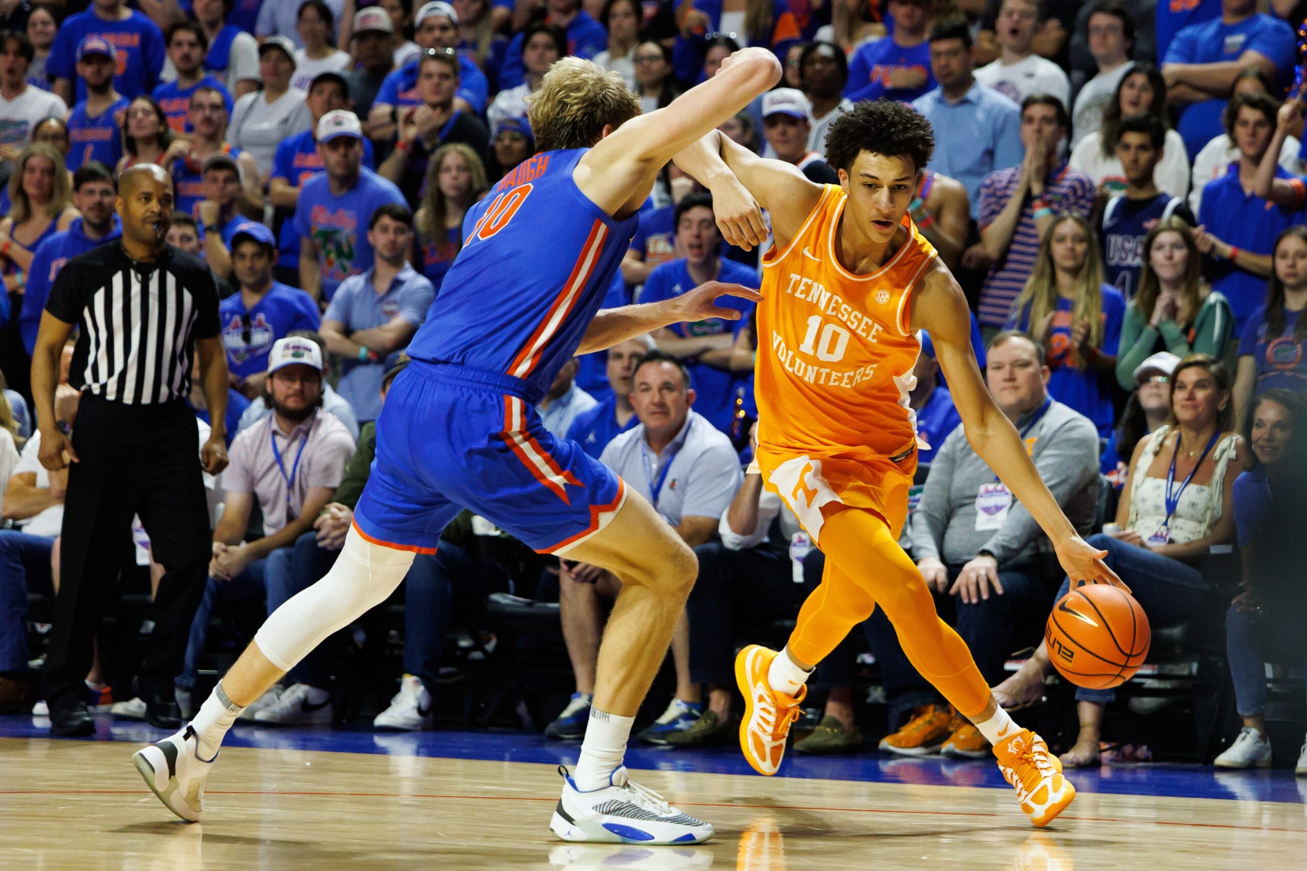 Jan 10, 2026; Gainesville, Florida, USA; Tennessee Volunteers forward Nate Ament (10) drives to the basket at Florida Gators forward Thomas Haugh (10) during the first half at Exactech Arena at the Stephen C. O'Connell Center. Mandatory Credit: Matt Pendleton-Imagn Images