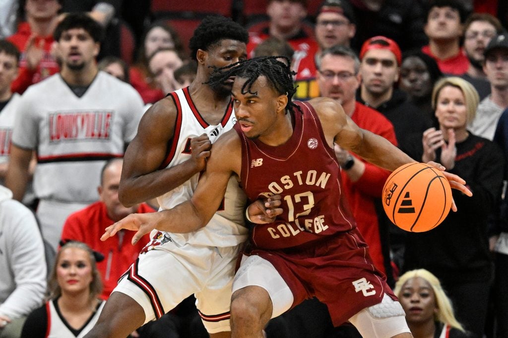 Jan 10, 2026; Louisville, Kentucky, USA; Boston College Eagles guard Donald Hand Jr. (13) posts up against Louisville Cardinals guard Kobe Rodgers (11) during the second half at KFC Yum! Center. Mandatory Credit: Jamie Rhodes-Imagn Images