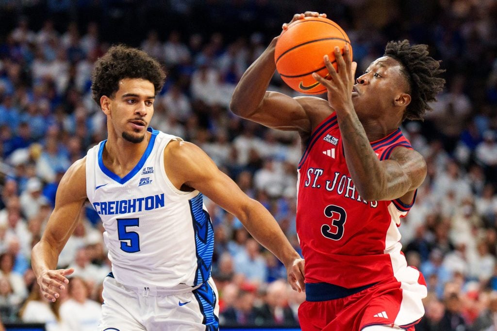 Jan 10, 2026; Omaha, Nebraska, USA; St. John's Red Storm guard Joson Sanon (3) drives to the hoop against Creighton Bluejays guard Nik Graves (5) during the first half at CHI Health Center Omaha. Mandatory Credit: Dylan Widger-Imagn Images