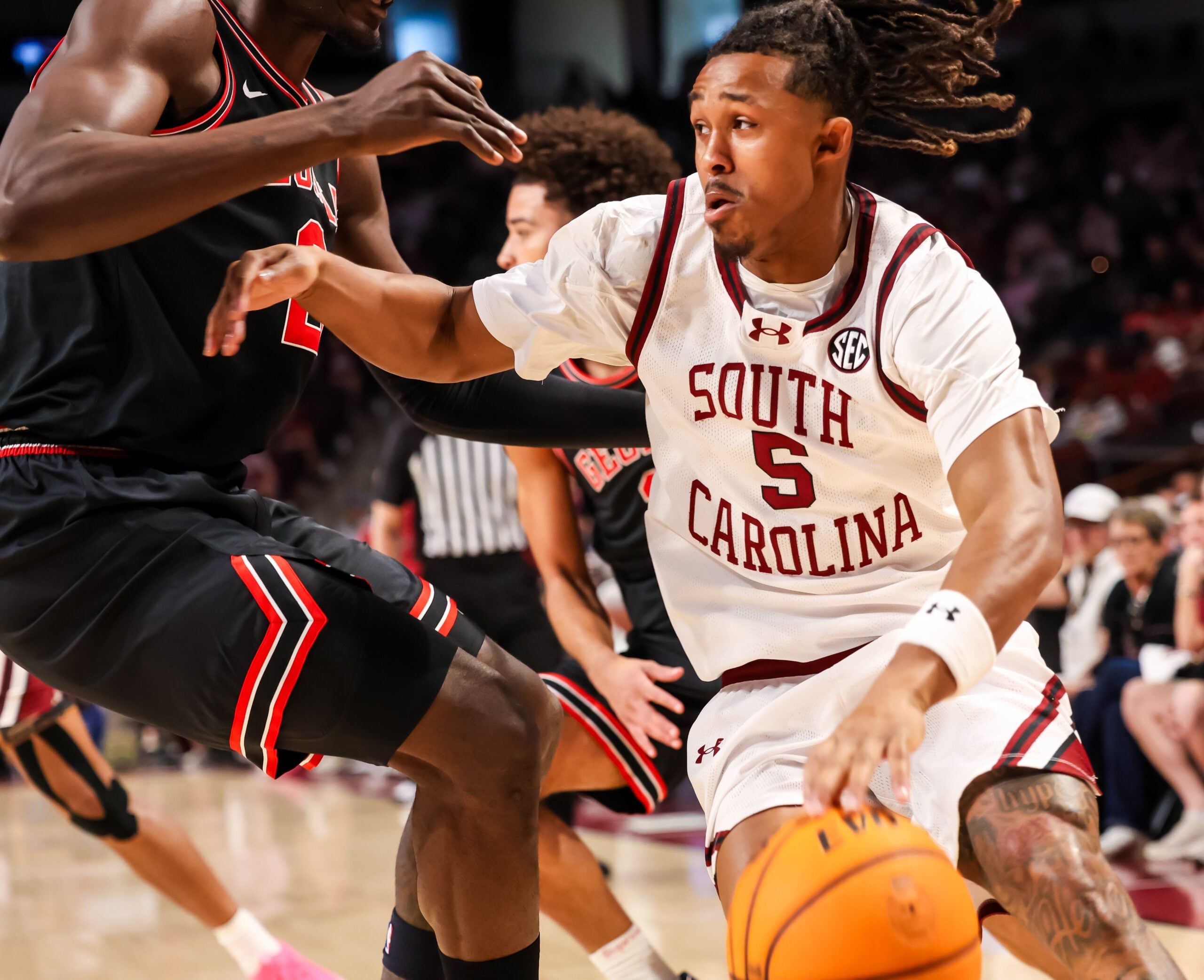Jan 10, 2026; Columbia, South Carolina, USA; South Carolina Gamecocks guard Meechie Johnson (5) drives past Georgia Bulldogs center Somto Cyril (2) in the first half at Colonial Life Arena. Mandatory Credit: Jeff Blake-Imagn Images