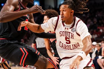 Jan 10, 2026; Columbia, South Carolina, USA; South Carolina Gamecocks guard Meechie Johnson (5) drives past Georgia Bulldogs center Somto Cyril (2) in the first half at Colonial Life Arena. Mandatory Credit: Jeff Blake-Imagn Images