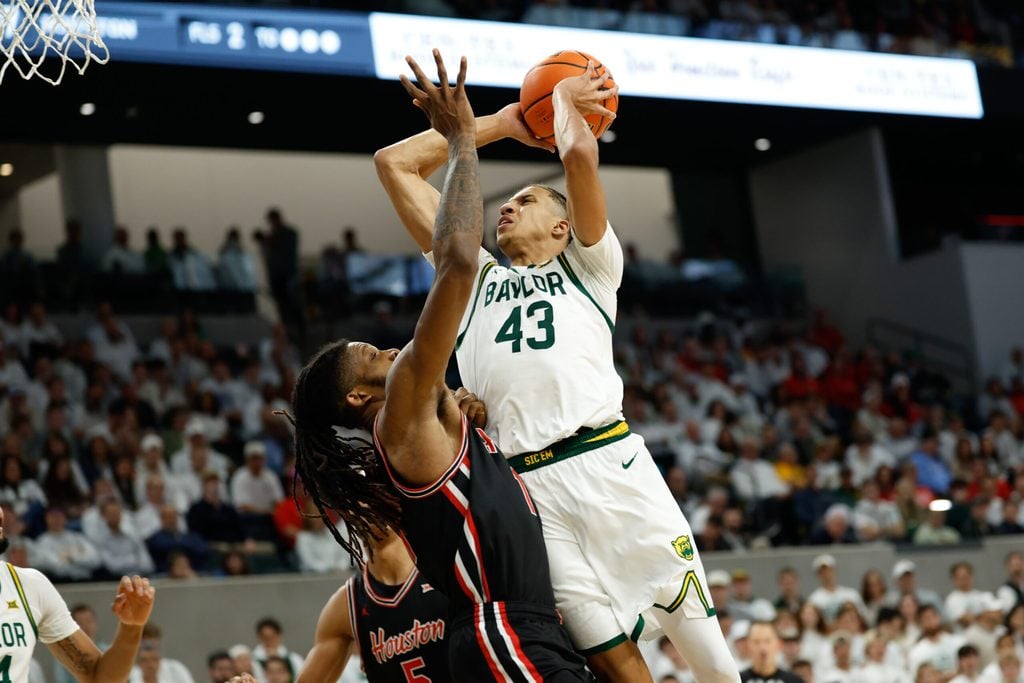 Jan 10, 2026; Waco, Texas, USA; Baylor Bears guard Cameron Carr (43) shoots as Houston Cougars forward Joseph Tugler (11) defends during the second half at Paul and Alejandra Foster Pavilion. Mandatory Credit: Chris Jones-Imagn Images