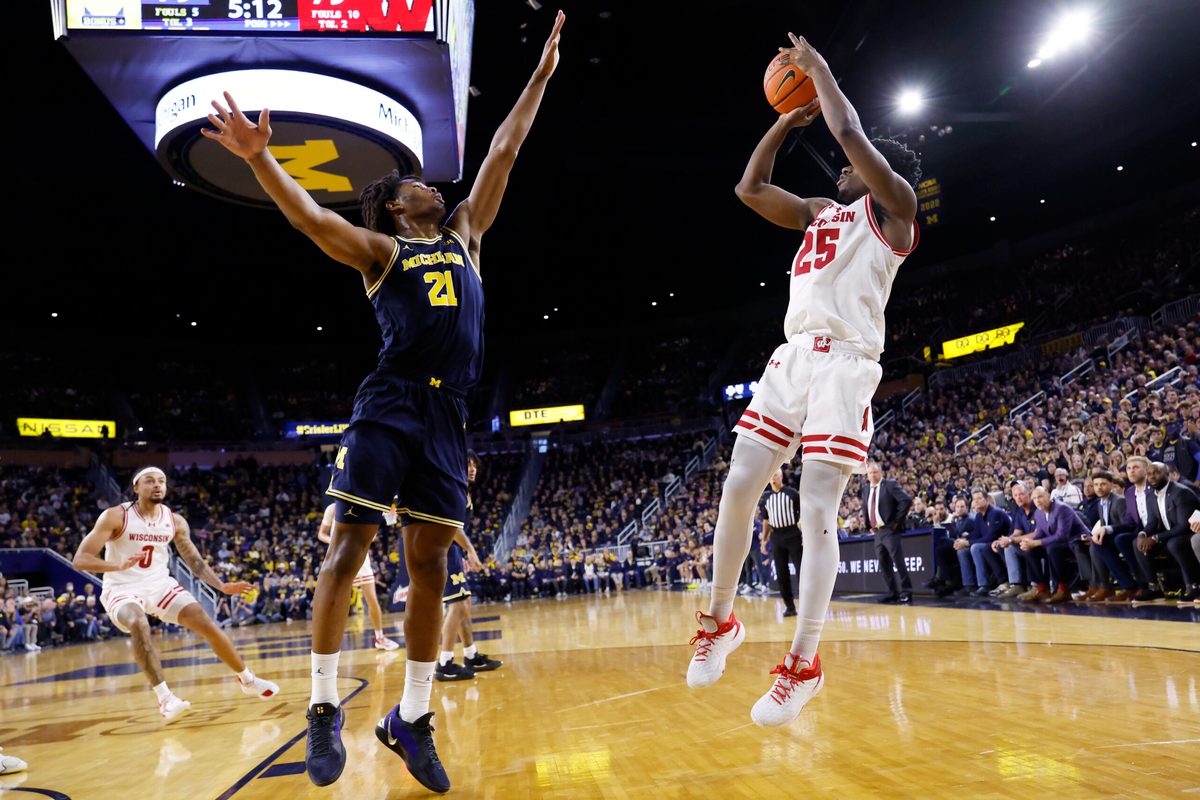 Jan 10, 2026; Ann Arbor, Michigan, USA; Wisconsin Badgers guard John Blackwell (25) shoots on Michigan Wolverines forward Morez Johnson Jr. (21) in the second half at Crisler Center. Mandatory Credit: Rick Osentoski-Imagn Images