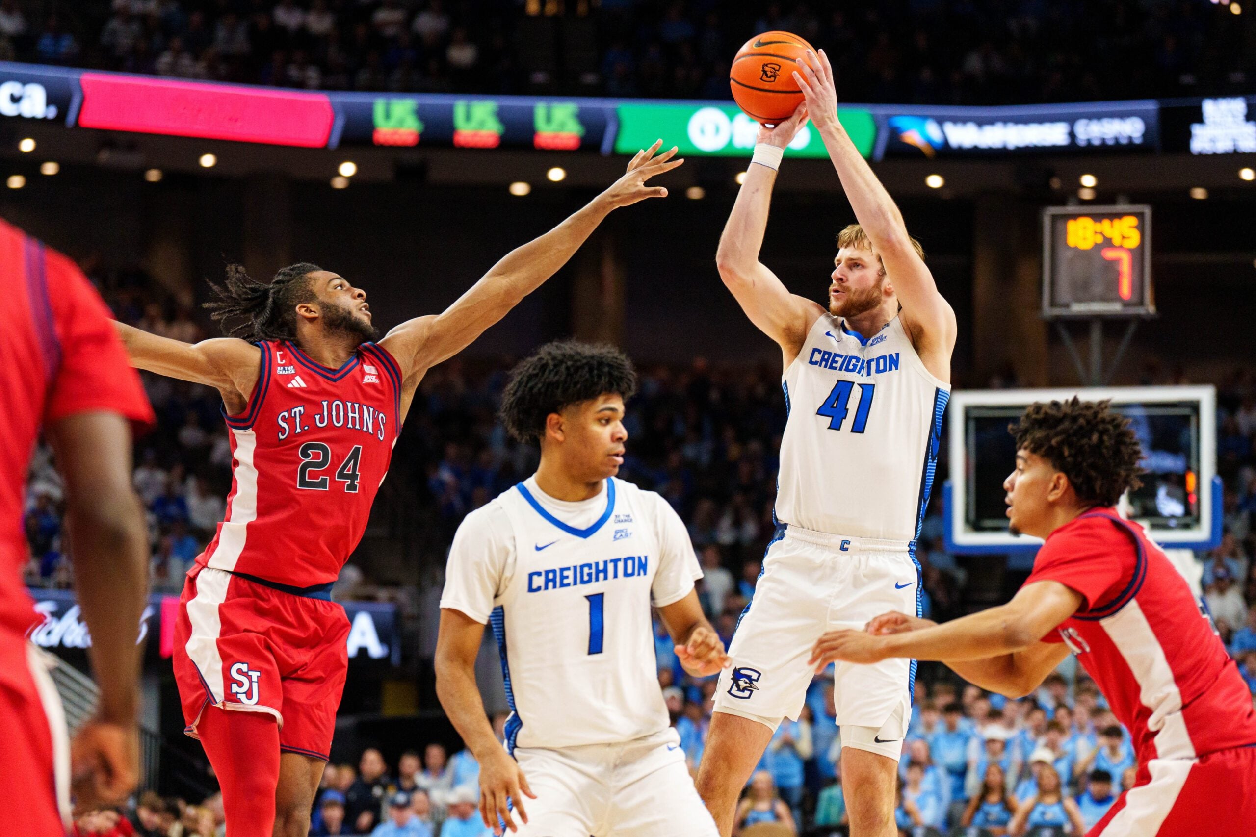 Jan 10, 2026; Omaha, Nebraska, USA; Creighton Bluejays forward Isaac Traudt (41) shoots the ball against St. John's Red Storm forward Zuby Ejiofor (24) during the second half at CHI Health Center Omaha. Mandatory Credit: Dylan Widger-Imagn Images