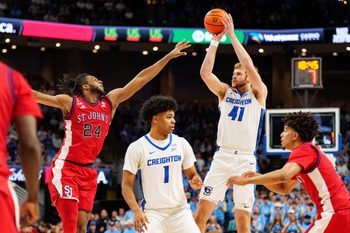 Jan 10, 2026; Omaha, Nebraska, USA; Creighton Bluejays forward Isaac Traudt (41) shoots the ball against St. John's Red Storm forward Zuby Ejiofor (24) during the second half at CHI Health Center Omaha. Mandatory Credit: Dylan Widger-Imagn Images