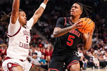 Jan 10, 2026; Columbia, South Carolina, USA; Georgia Bulldogs guard Jeremiah Wilkinson (5) looks to get around South Carolina Gamecocks guard Meechie Johnson (5) in the second half at Colonial Life Arena. Mandatory Credit: Jeff Blake-Imagn Images