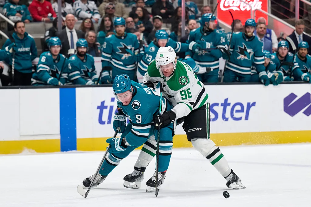 Jan 10, 2026; San Jose, California, USA; San Jose Sharks defender Dmitry Orlov (9) vies for the puck against Dallas Stars right wing Mikko Rantanen (96) during the first period at SAP Center at San Jose. Mandatory Credit: Robert Edwards-Imagn Images