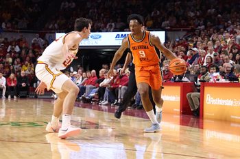 Jan 10, 2026; Ames, Iowa, USA; Iowa State Cyclones forward Milan Momcilovic (22) defends Oklahoma State Cowboys guard Anthony Roy (9) during the second half at James H. Hilton Coliseum. Mandatory Credit: Reese Strickland-Imagn Images