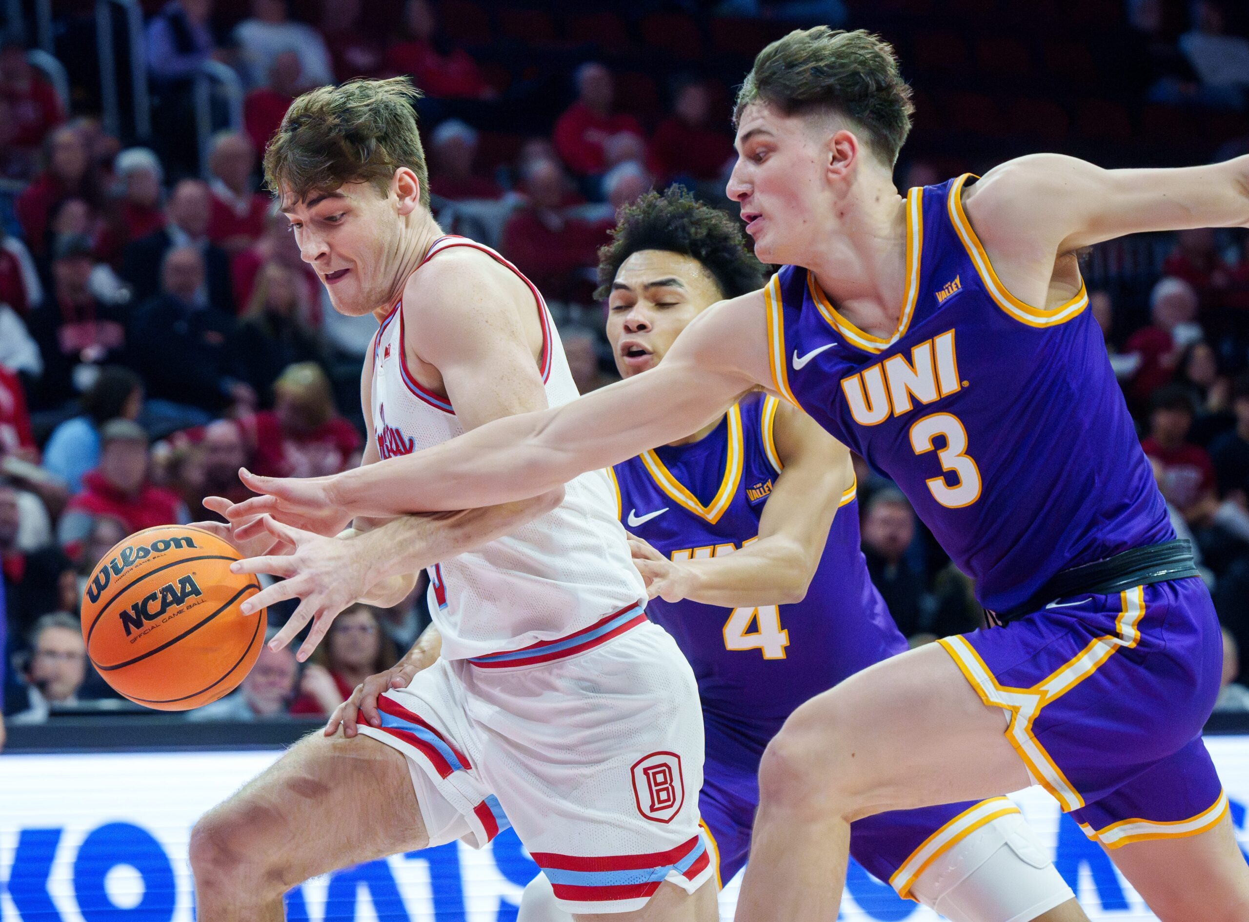 Northern Iowa's Max Weisbrod tries to knock the ball away from Bradley's Alex Huibregtse in the first half of their college basketball game Saturday, Jan. 10, 2026 at Carver Arena in Peoria. The Braves defeated the Panthers 75-69.