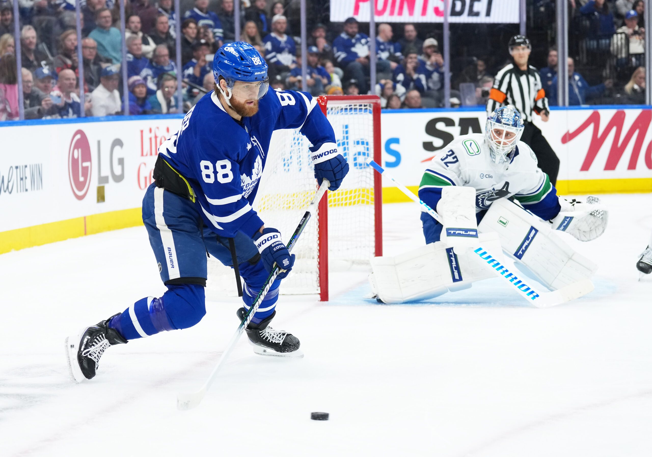 Jan 10, 2026; Toronto, Ontario, CAN; Toronto Maple Leafs right wing William Nylander (88) stick handles the puck at the side of the Vancouver Canucks net during the third period at Scotiabank Arena. Mandatory Credit: Nick Turchiaro-Imagn Images