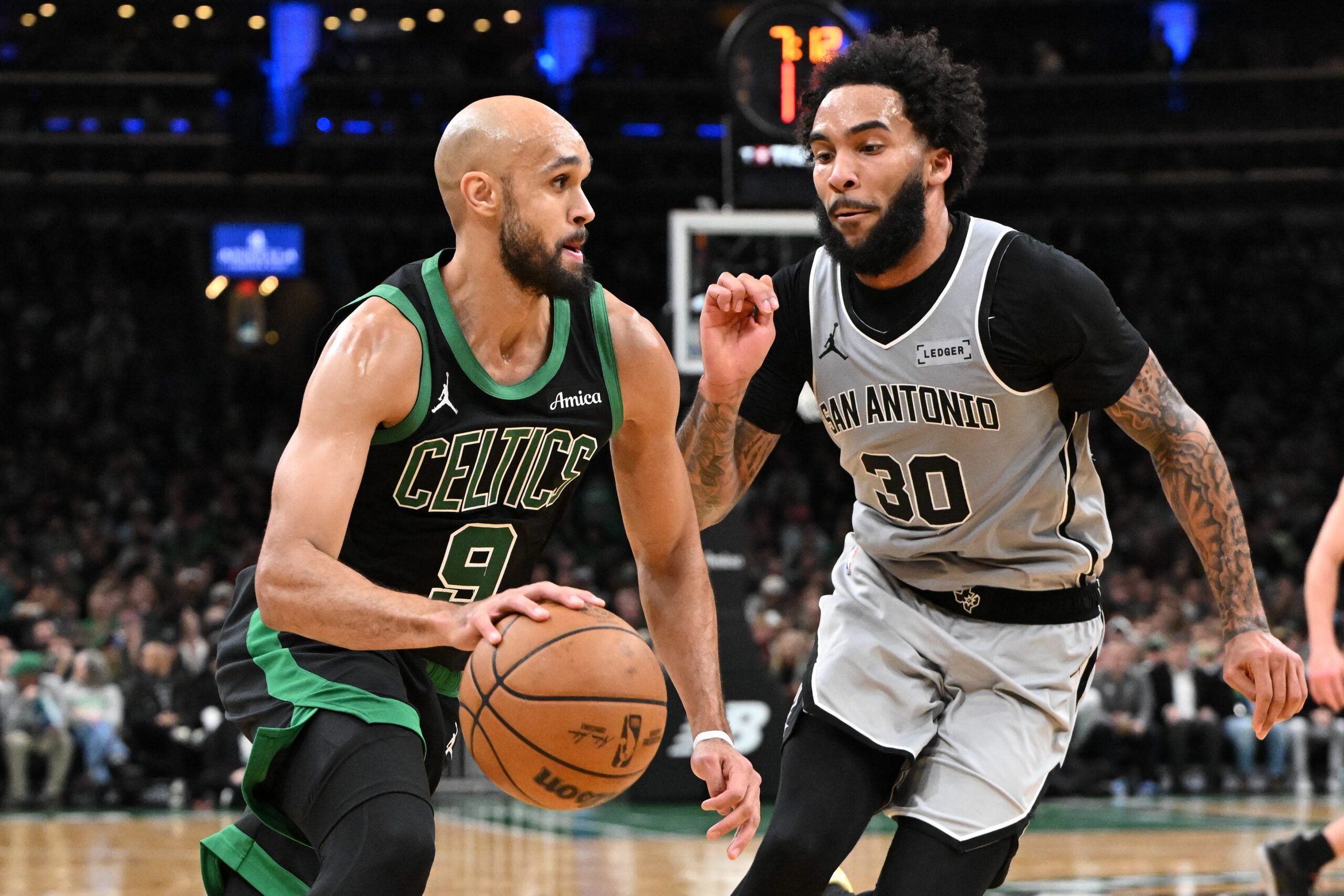 Jan 10, 2026; Boston, Massachusetts, USA; Boston Celtics guard Derrick White (9) drives to the basket against San Antonio Spurs forward Julian Champagne (30) during the second half at the TD Garden. Mandatory Credit: Brian Fluharty-Imagn Images
