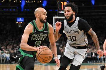 Jan 10, 2026; Boston, Massachusetts, USA; Boston Celtics guard Derrick White (9) drives to the basket against San Antonio Spurs forward Julian Champagne (30) during the second half at the TD Garden. Mandatory Credit: Brian Fluharty-Imagn Images