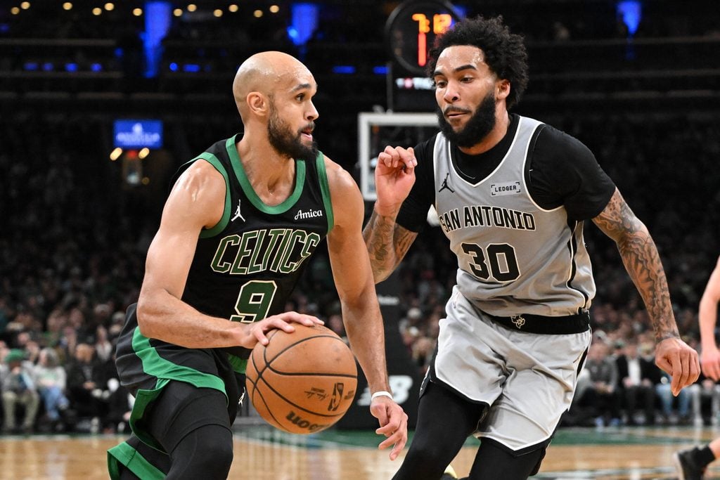 Jan 10, 2026; Boston, Massachusetts, USA; Boston Celtics guard Derrick White (9) drives to the basket against San Antonio Spurs forward Julian Champagne (30) during the second half at the TD Garden. Mandatory Credit: Brian Fluharty-Imagn Images