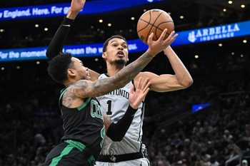 Jan 10, 2026; Boston, Massachusetts, USA; Boston Celtics guard Anfernee Simons (4) attempts a basket against San Antonio Spurs forward Victor Wembanyama (1) during the second half at the TD Garden. Mandatory Credit: Brian Fluharty-Imagn Images