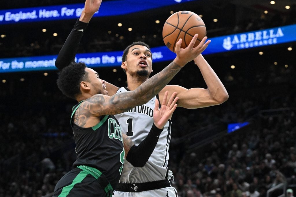 Jan 10, 2026; Boston, Massachusetts, USA; Boston Celtics guard Anfernee Simons (4) attempts a basket against San Antonio Spurs forward Victor Wembanyama (1) during the second half at the TD Garden. Mandatory Credit: Brian Fluharty-Imagn Images