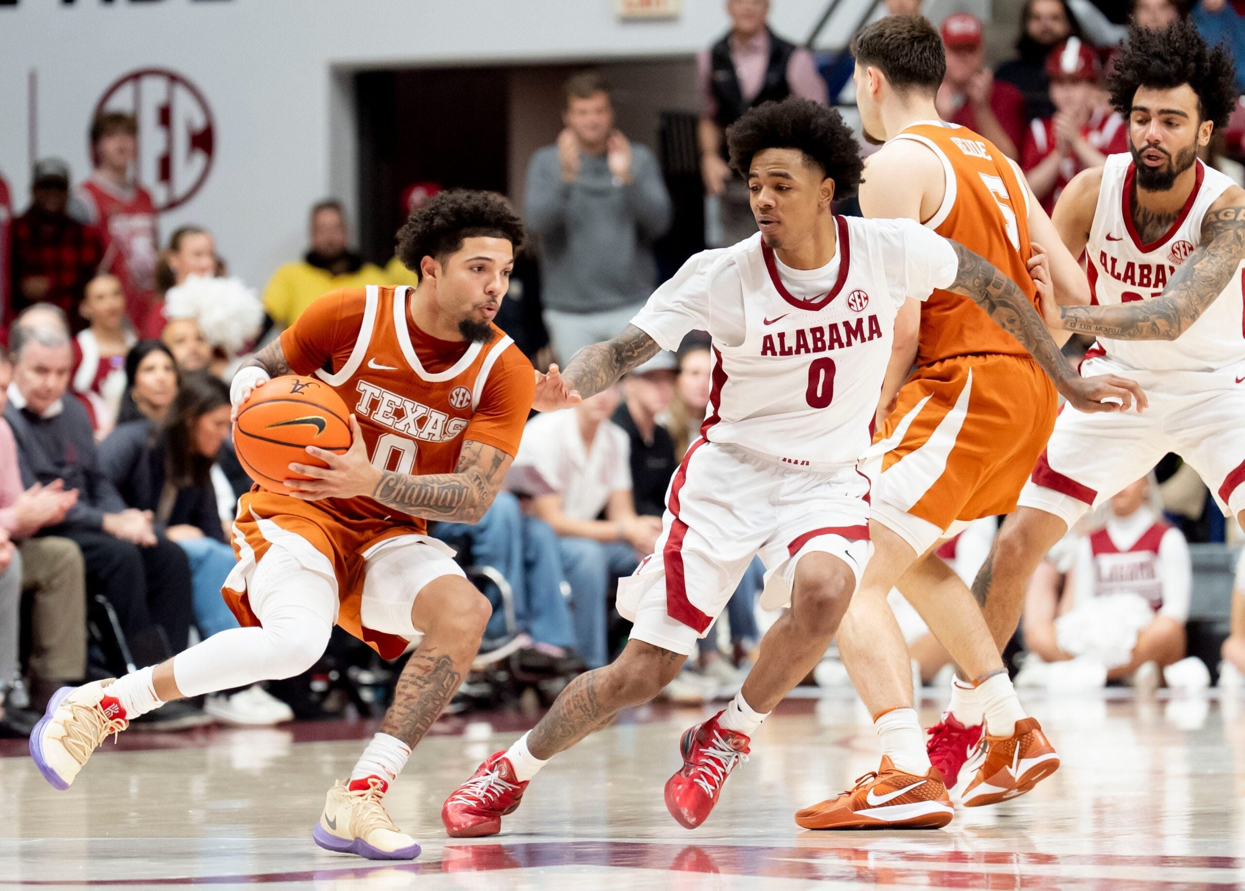 Jan 10, 2026; Tuscaloosa, AL, USA; Alabama guard Labaron Philon Jr. (0) defends as Texas guard Jordan Pope (0) maneuvers for a shot at Coleman Coliseum. Texas defeated Alabama 92-88. Mandatory Credit: Gary Cosby Jr.-Tuscaloosa News