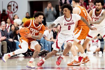 Jan 10, 2026; Tuscaloosa, AL, USA; Alabama guard Labaron Philon Jr. (0) defends as Texas guard Jordan Pope (0) maneuvers for a shot at Coleman Coliseum. Texas defeated Alabama 92-88. Mandatory Credit: Gary Cosby Jr.-Tuscaloosa News